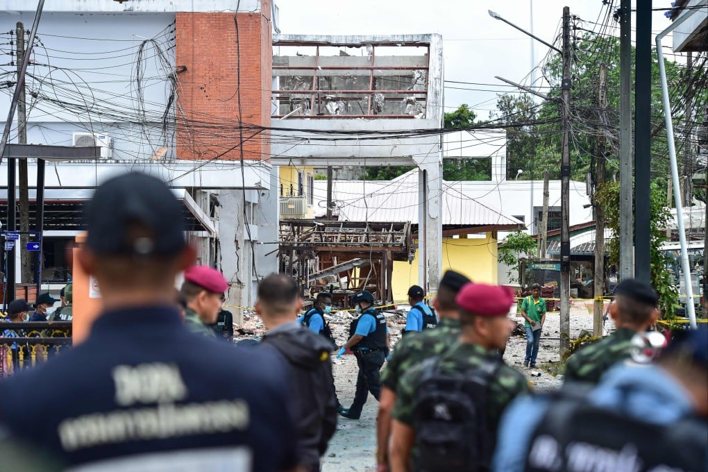 Thai police on Sunday inspect the site of an attack in Sungai Kolok that killed two security personnel and injured 12 others. Photo: AFP
