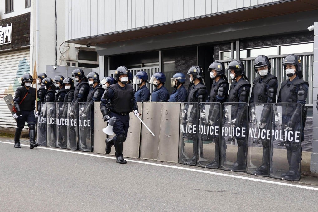 Japanese riot police stand guard outside an organised crime syndicate’s office in Ota, Gunma prefecture, on March 4. Photo: Kyodo