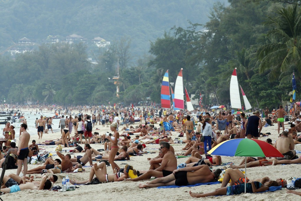 Foreign tourists sunbathe at Patong beach, Phuket island, in southern Thailand. Photo: EPA-EFE