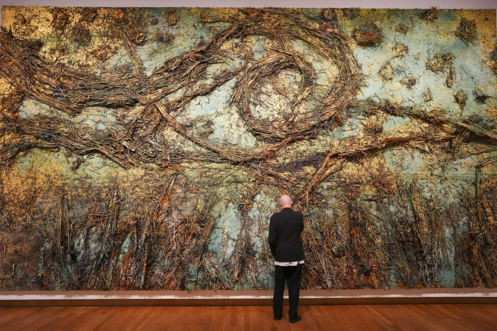 German artist Anselm Kiefer adjusts a piece of his artwork The Starry Night at a preview of exhibitions of his work at the Van Gogh Museum and Stedelijk Museum in Amsterdam, Netherlands. Photo: AP