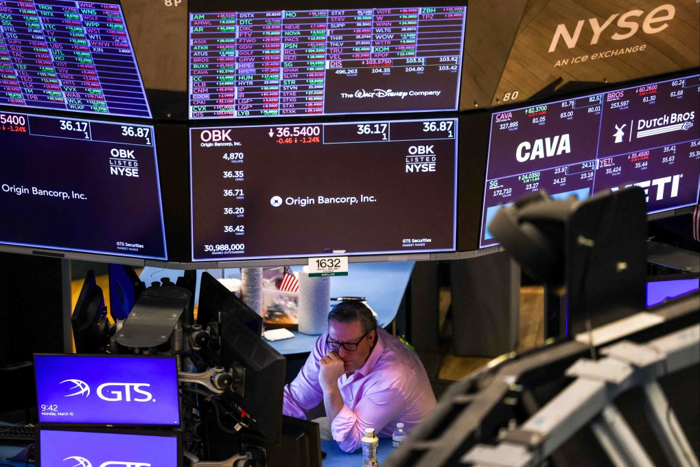 A trader works on the floor of the New York Stock Exchange at the opening bell in New York City on March 10, 2025. Photo: AFP