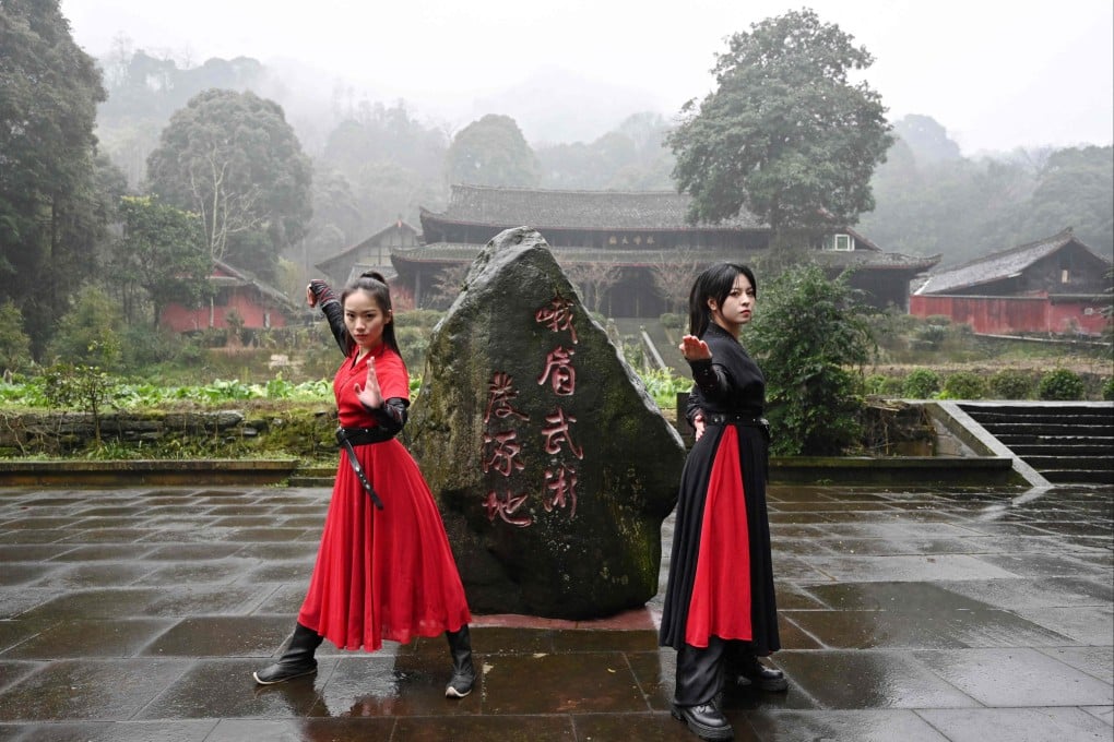 Duan Ruru and Liu Qiao demonstrate their martial art techniques in the mountainous area of Emeishan. Their troupe has amassed more than 23 million views on Douyin. Photo: AFP