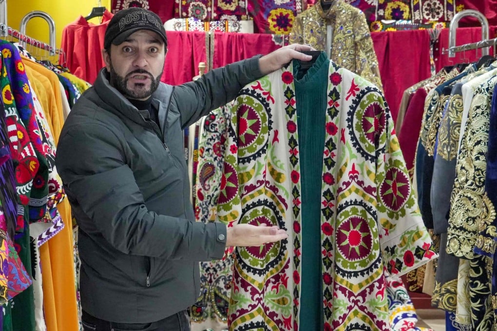 Tajik fashion designer Khurshed Sattorov presents traditional garb at his workshop. Women in Tajikistan are being advised by the government to wear more “Tajik-style” clothing. Photo: AFP