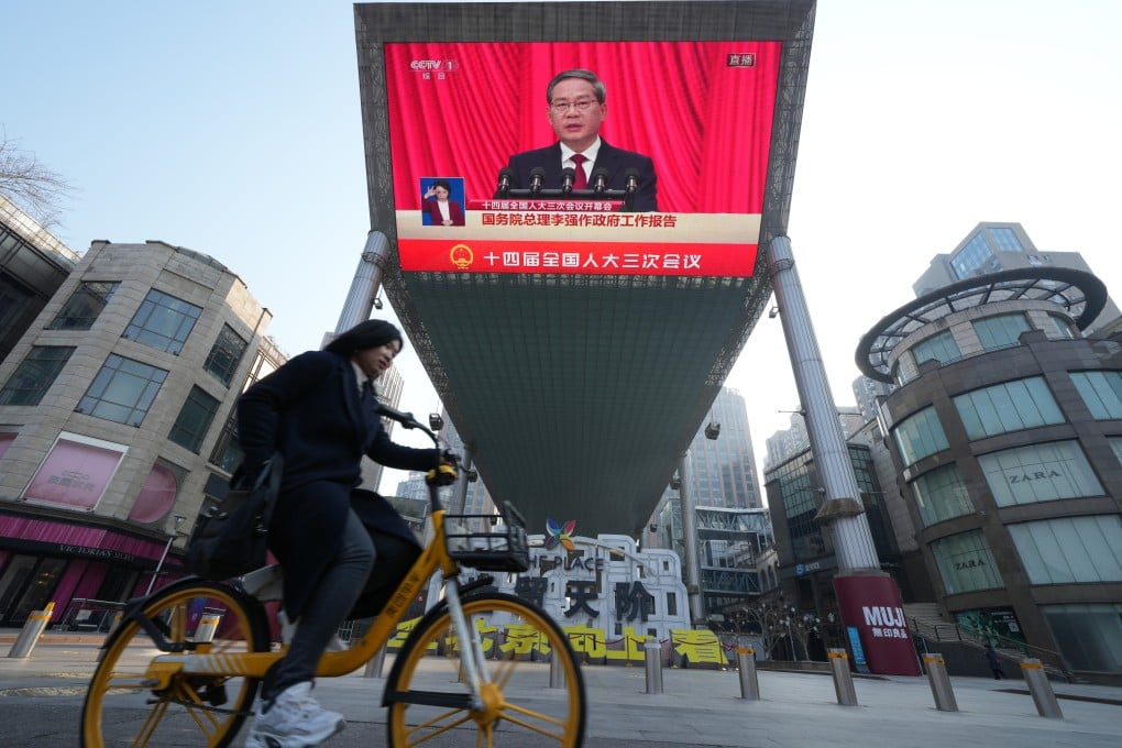 A screen at a shopping centre in Beijing shows Premier Li Qiang speaking during the opening of the annual session of China’s top legislature on Wednesday. Photo: Robert Ng