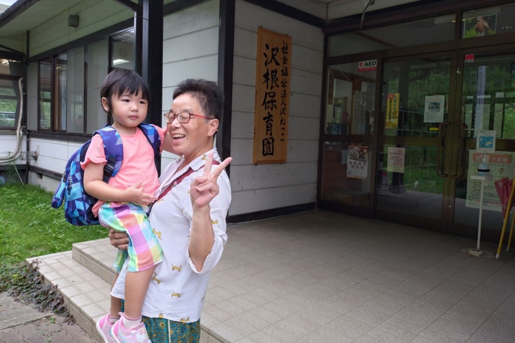 Evelyn Yau and her grandmother stand in front of the preschool that Yau attended, in Sado Island, as part of the programme offered by Japanese Preschool Exchange. Photo: courtesy of Joyce Chen