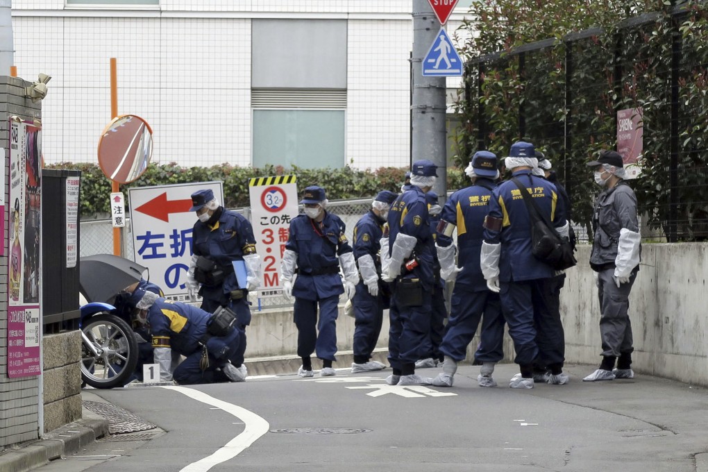 Japanese police officers at the scene of a stabbing of a woman in the Shinjuku district of Tokyo on March 11. Photo: Kyodo News via AP