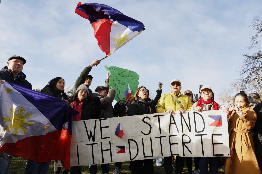 Supporters of former Philippine president Rodrigo Duterte wave a flag and banner during a demonstration outside the International Criminal Court detention centre near The Hague in Scheveningen, Netherlands, on Wednesday. Photo: AP