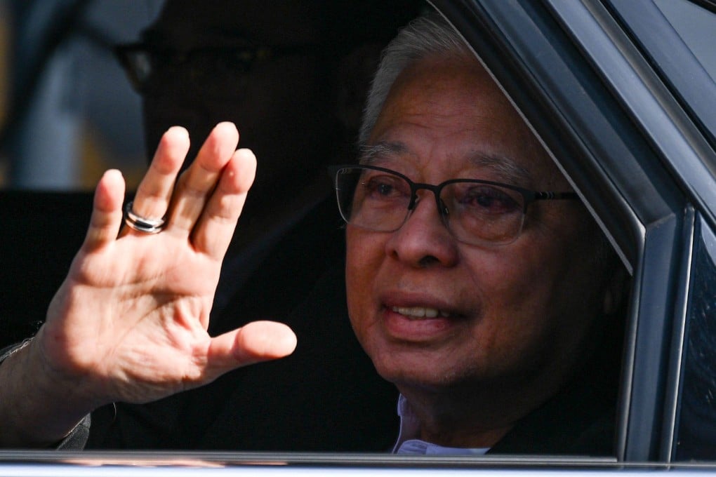 Former Malaysian prime minister Ismail Sabri Yaakob waves as he arrives to give a statement at the Malaysian Anti-Corruption Commission in Putrajaya on Thursday. Photo: AFP