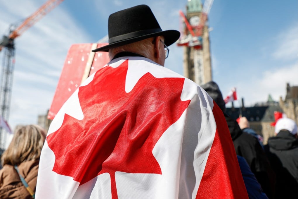 A man wearing a Canadian flag attends the “Elbows up” rally on Parliament Hill in Ottawa, Ontario, Canada on Sunday. Photo: Reuters