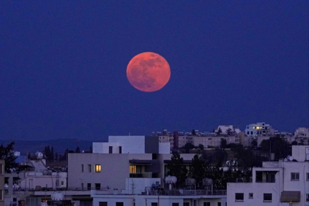 The “Super Blood Moon” rises over the Cypriot capital Nicosia on May 26, 2021. Photo: AFP