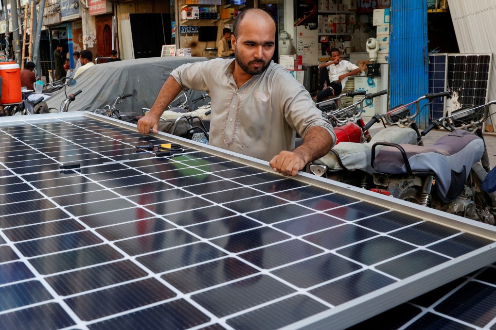 A worker loads solar panels on a vehicle in Karachi, Pakistan. Photo: Reuters