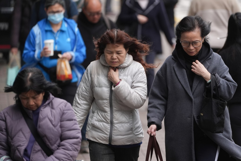 Pedestrians in Central dress in warm clothes. Photo: Eugene Lee