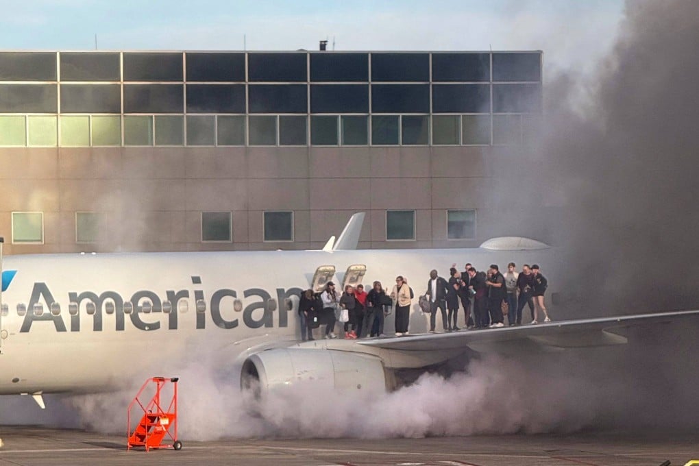 Passengers standing on the wing of an American Airlines plane at Denver International Airport. Photo: Branden Williams via AFP