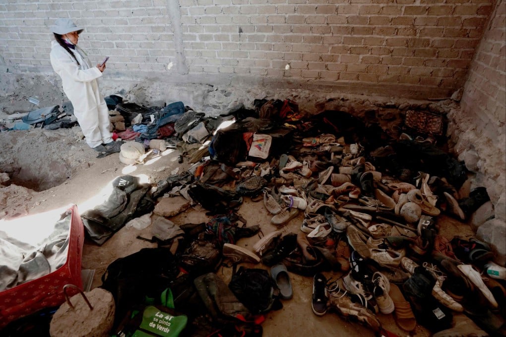A woman records clothes and shoes found at the Izaguirre Ranch in Teuchitlan, Jalisco state, Mexico. Photo: AFP