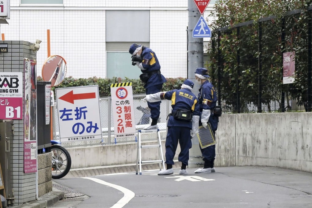 Japanese police officers at the scene of a stabbing of a woman in the Shinjuku district of Tokyo on March 11. Photo: Kyodo News via AP