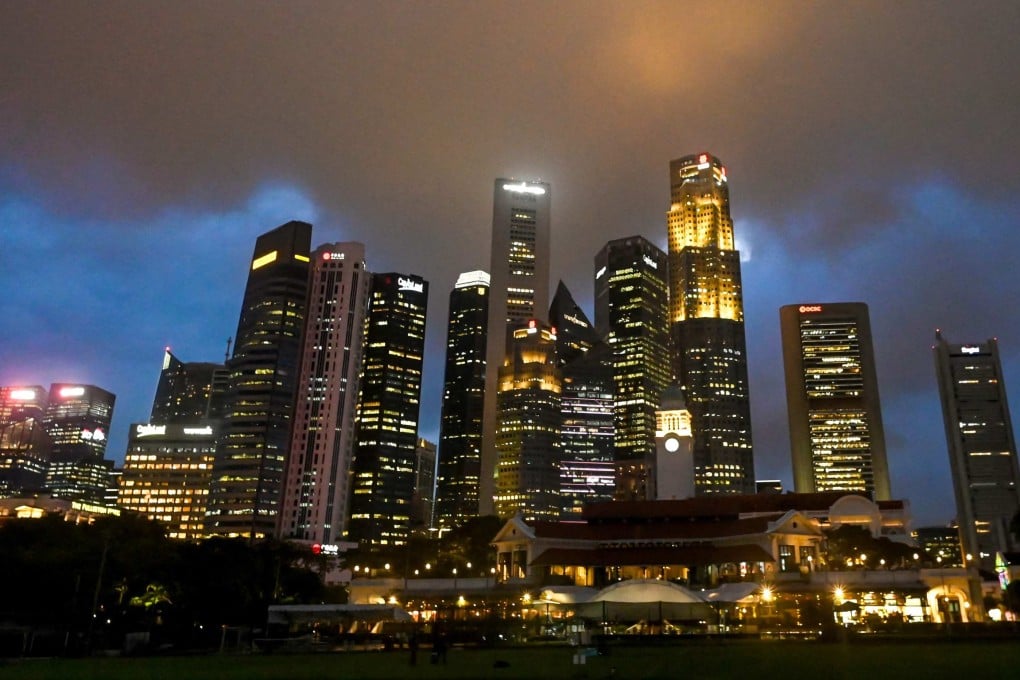 Dark clouds gather above commercial buildings in Singapore. Photo: AFP