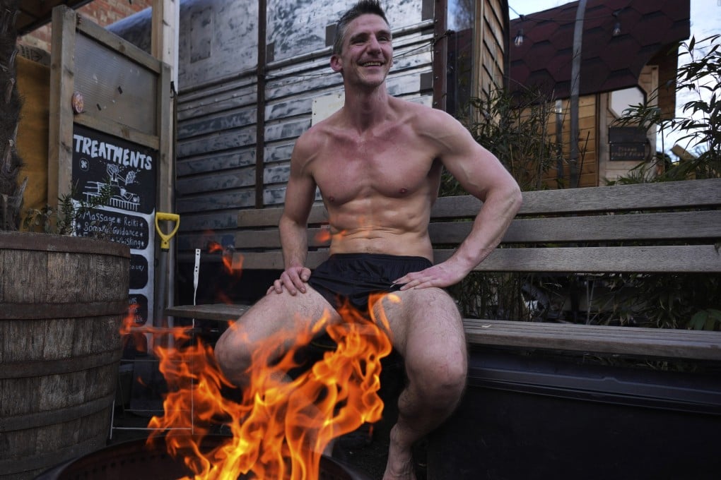 David Saville sits by a camp fire during his sauna session at the Community Sauna Baths, in Hackney, London. Saunas are the latest wellness trend in the UK. Photo: AP