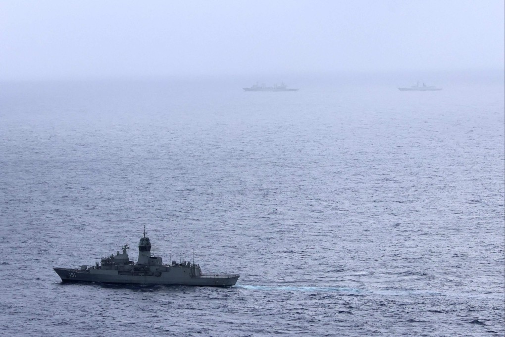 Australian navy ship HMAS Arunta (lower left) sails near a Chinese navy replenishment vessel and frigate in the Tasman Sea on February 13. 
Photo: Australian Defence Force/ AFP