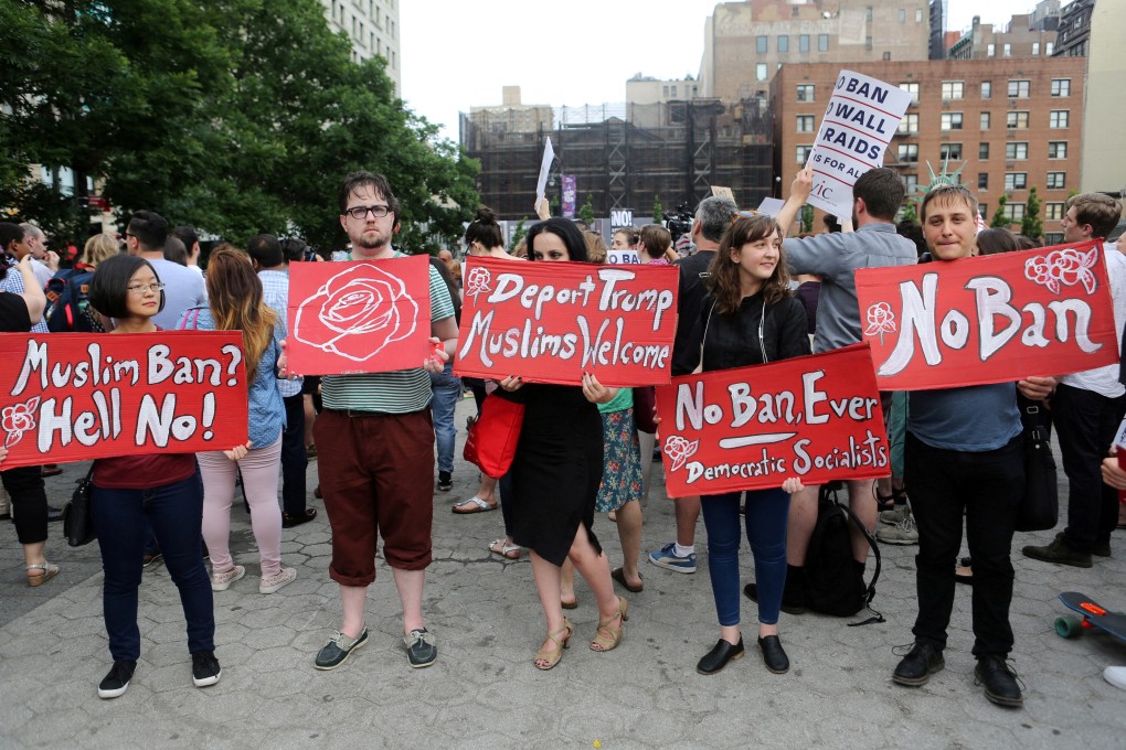 Protesters hold signs in New York against US President Donald Trump’s limited travel ban in 2017. Photo: Reuters
