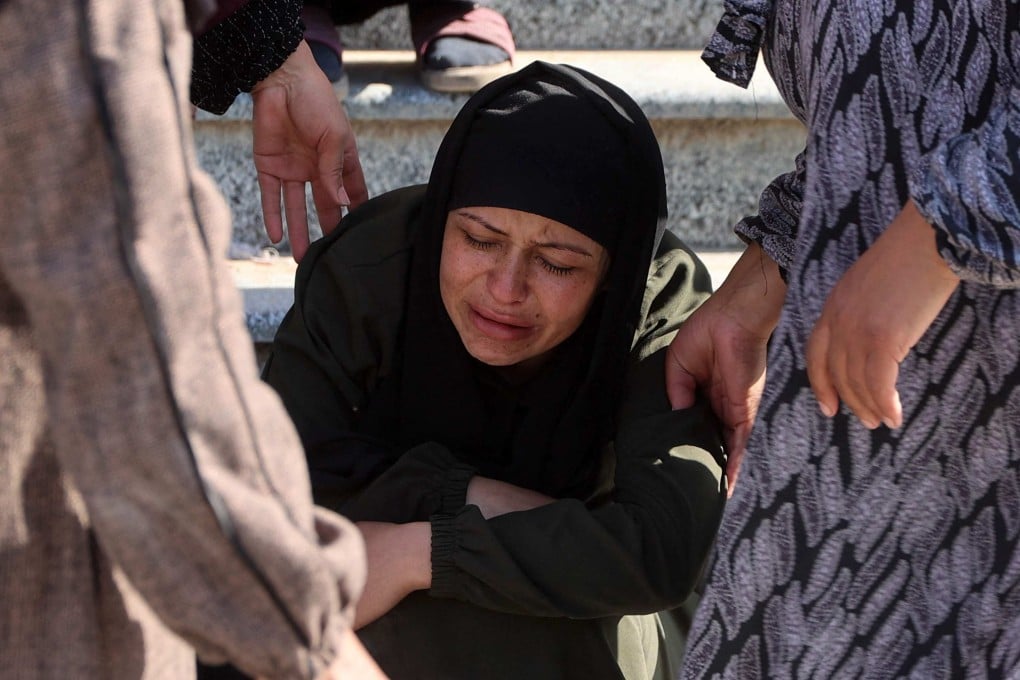 A woman is comforted as mourners bid farewell to victims killed by Israeli bombardment in Beit Lahia in the northern Gaza Strip on Saturday. Photo: AF