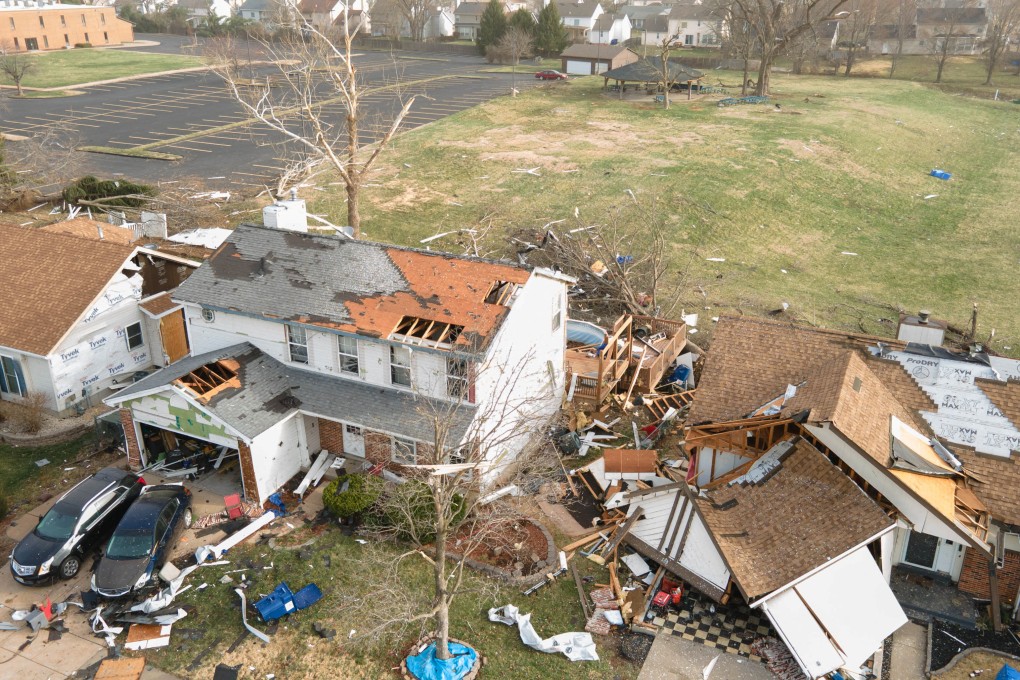 Debris lies around damaged houses on Saturday, the morning after a tornado touched down in Florissant, Missouri. Photo: Reuters