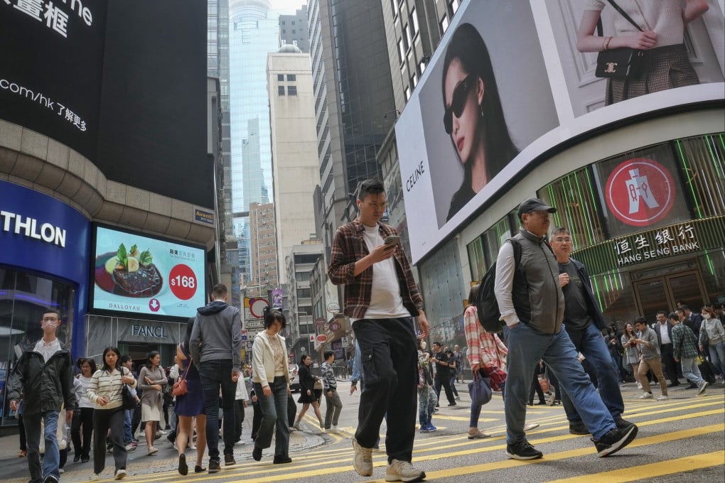 Pedestrians cross a road in Central at noon time on March 14, 2025. Photo: Elson Li