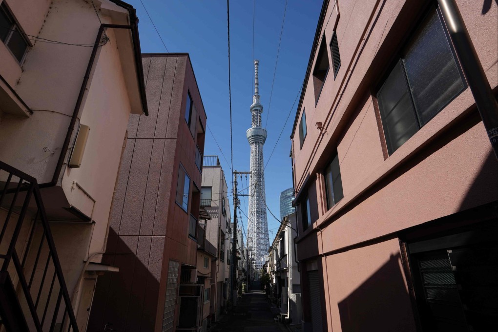 Tokyo Skytree stands between buildings in a residential area of Tokyo on February 20. Photo: AFP