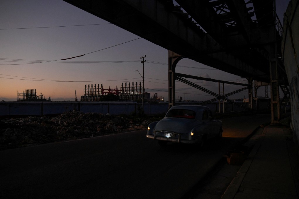 A vintage car passes near powerboats docked at Havana’s bay during a national electrical grid collapse. Photo: Reuters