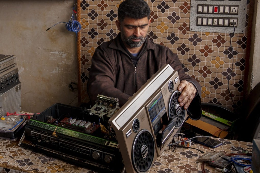 Self-taught tape recorder mechanic Mohammad Ashraf Matoo repairs a tape recorder at his shop in Srinagar, Indian-administered Kashmir. Cassette tapes remain popular in the region among lovers of its Sufi music. Photo: AP