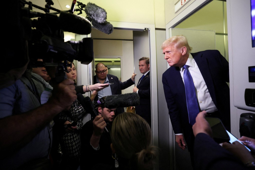 US President Donald Trump speaks to reporters aboard Air Force One. Photo: Reuters