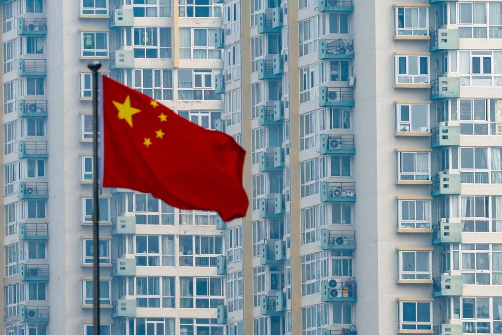 A Chinese national flag flutters near residential buildings in Beijing on March 9, 2025. Photo: Reuters