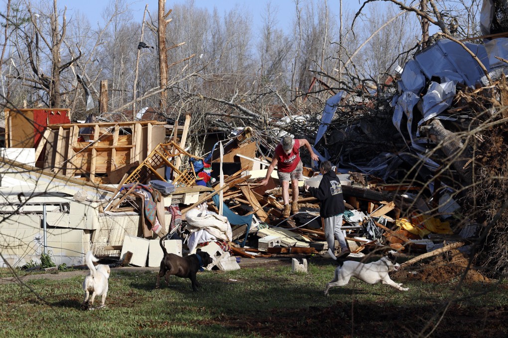 Residents look for personal belongings at their damaged home on Sunday after a tornado passed through Plantersville, Alabama. Photo: AP