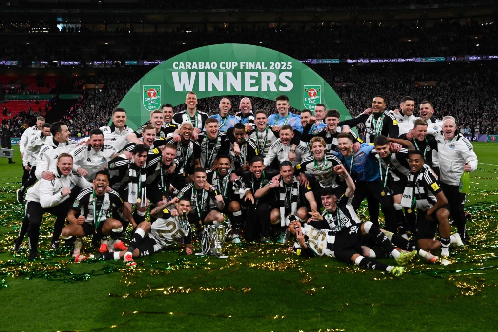 Newcastle United players celebrate with the Carabao Cup trophy after beating Liverpool 2-1 at Wembley. Photo: AFP