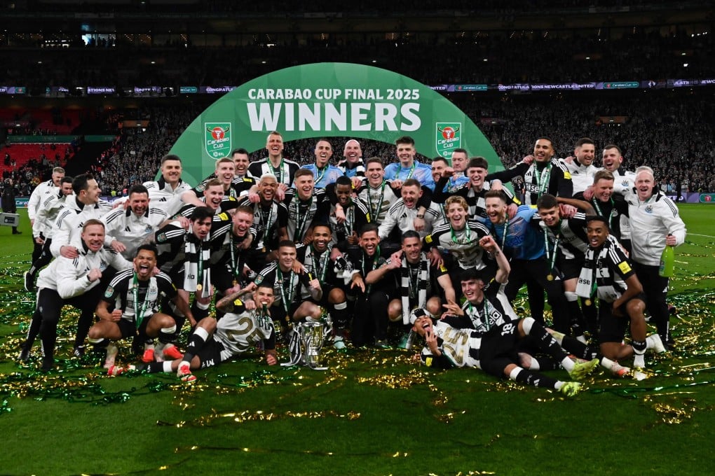 Newcastle United players celebrate with the Carabao Cup trophy after beating Liverpool 2-1 at Wembley. Photo: AFP
