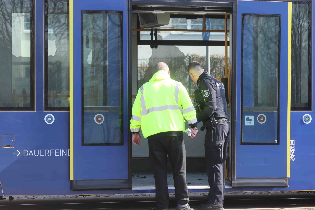 Police and firefighters are deployed after an arson attack on a streetcar. Photo: dpa