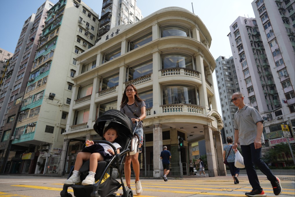 Pedestrians walk past Lui Seng Chun, a tong lau in Sham Shui Po that now houses a Chinese medicine and healthcare centre used by the Hong Kong Baptist University, in August 2014. Photo: May Tse