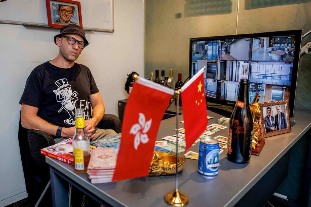 Hong Kong-based British artist Dominic Johnson-Hill sits with his installation in the “boss’ office” at “Re:Urgent”, an exhibition at Young Soy Gallery in Central, Hong Kong. Photo: AFP