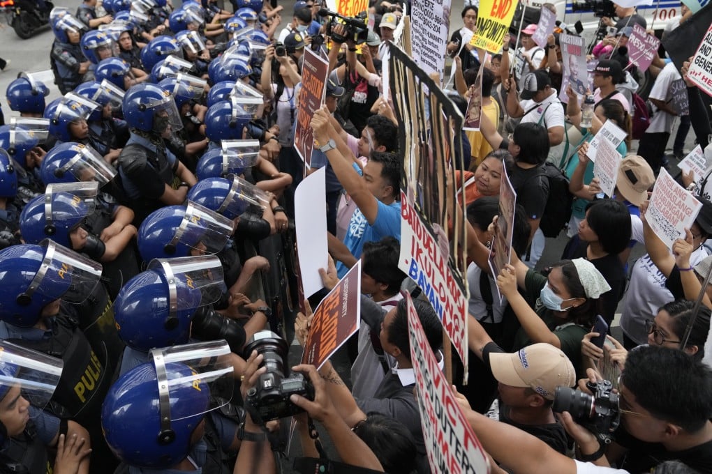 Police block protesters during a rally in Manila on Monday calling for the Philippines to rejoin the International Criminal Court. Photo: AP