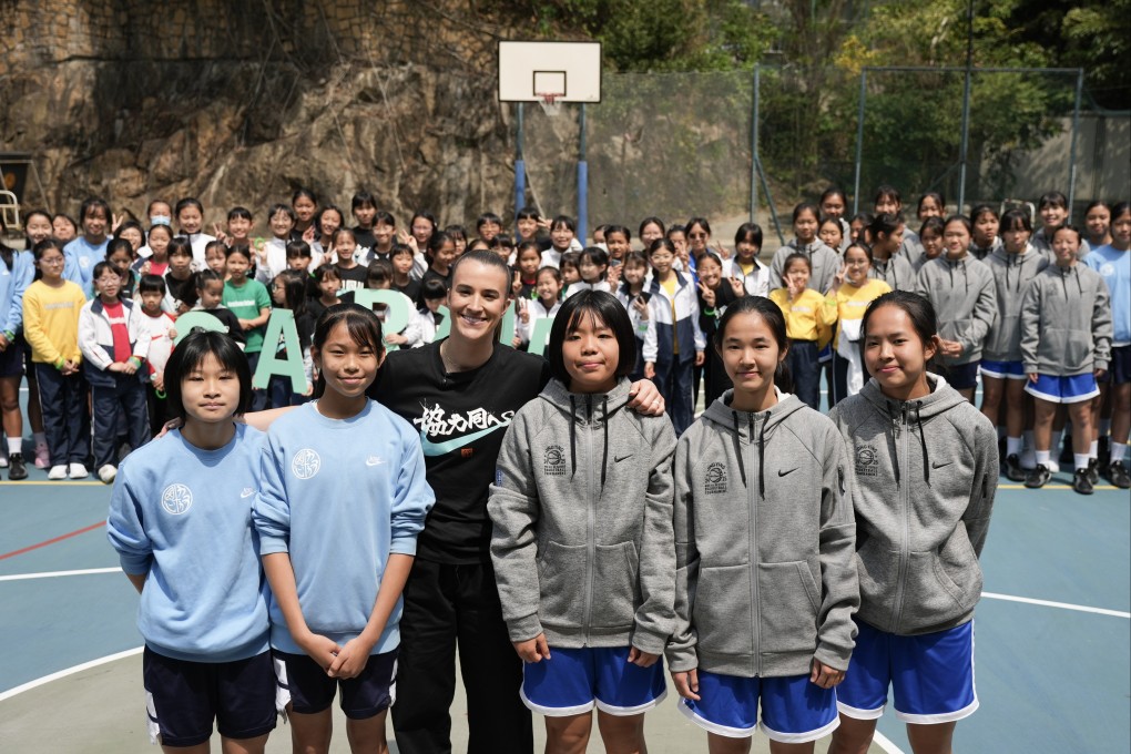 Sabrina Ionescu poses with students as she visits Heep Yunn School in Hong Kong. Photo: Eugene Lee