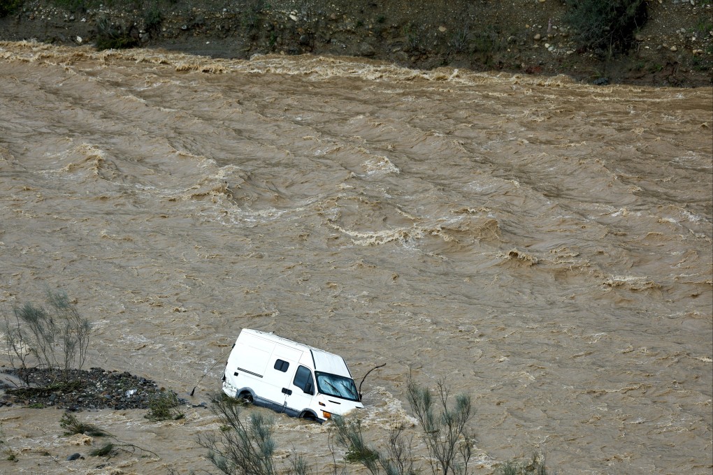A van being swept away by the current of the Campanillas river in Almogia, Malaga province, Spain. Photo: EPA-EFE