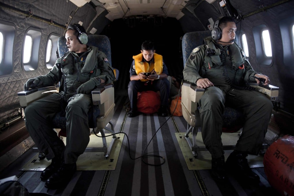 Crew members on a Malaysian Air Force aircraft during a search and rescue operation to find the missing Malaysia Airlines flight MH370 plane over the Strait of Malacca on March 14, 2014. Photo: AFP
