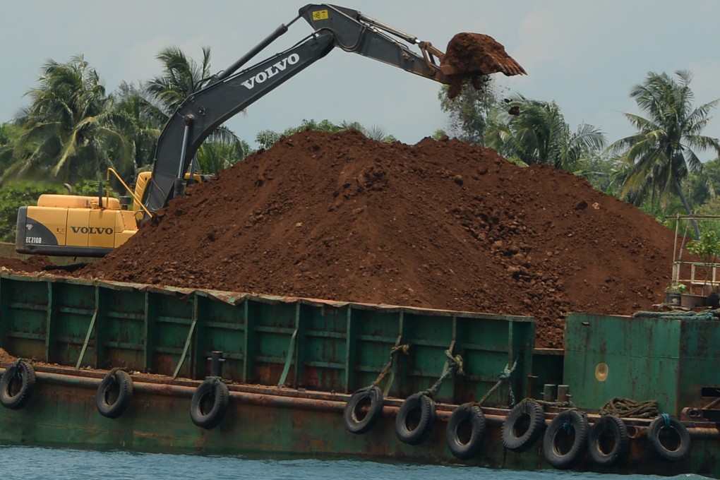A barge being loaded with nickel ore at in Infanta, Philippines. Photo: AFP