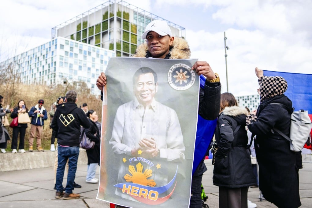 A supporter of former Philippine president Rodrigo Duterte displays his portrait as they gather in front of the International Criminal Court (ICC) in The Hague, The Netherlands, on March 14. Photo: EPA-EFE