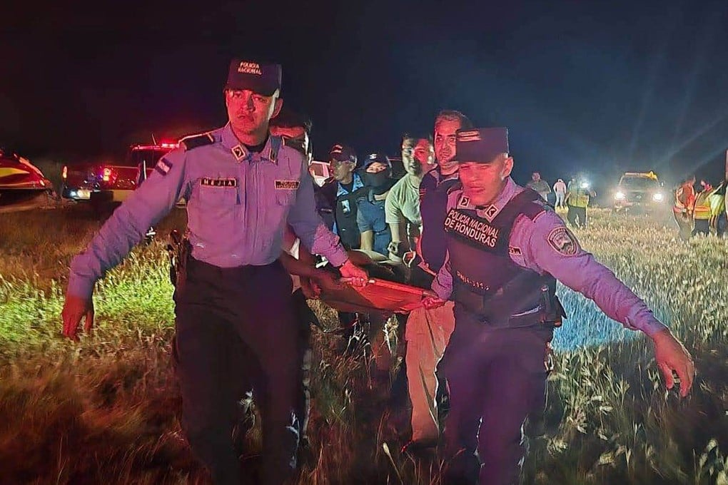 Rescue teams carrying an injured man after a plane crash in Roatan, Honduras on Monday. Photo: Honduran Police / AFP