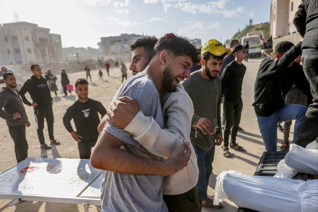 A Palestinian man weeps next to a truck carrying the bodies of the victims of overnight Israeli strikes in northern Gaza on Tuesday. Photo: AFP