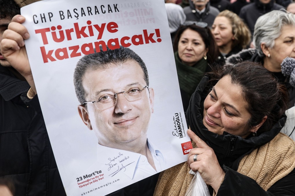 A supporter holds a poster depicting Istanbul Mayor Ekrem Imamoglu during a protest near the Istanbul Police Department following Imamoglu’s arrest in Istanbul, Turkey on Wednesday. Photo: EPA-EFE