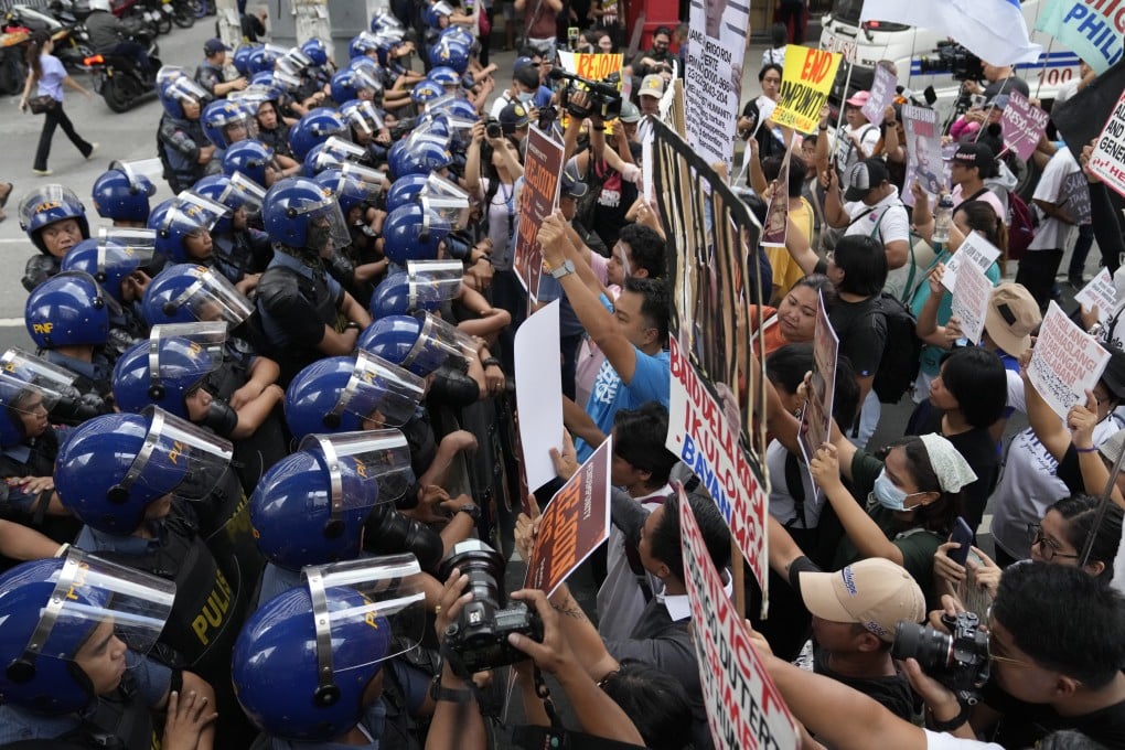 Police block protesters as they try to march towards Malacanang palace in Manila, Philippines, on March 17 to call on the government to rejoin the ICC after the arrest of former president Rodrigo Duterte. Photo: AP