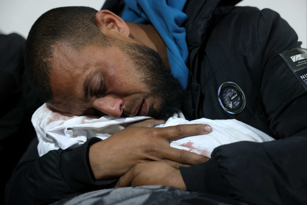 A Palestinian man hugs the body of a baby at the Indonesian Hospital in Beit Lahia, following Israeli overnight strikes in the northern Gaza Strip, Photo: AFP