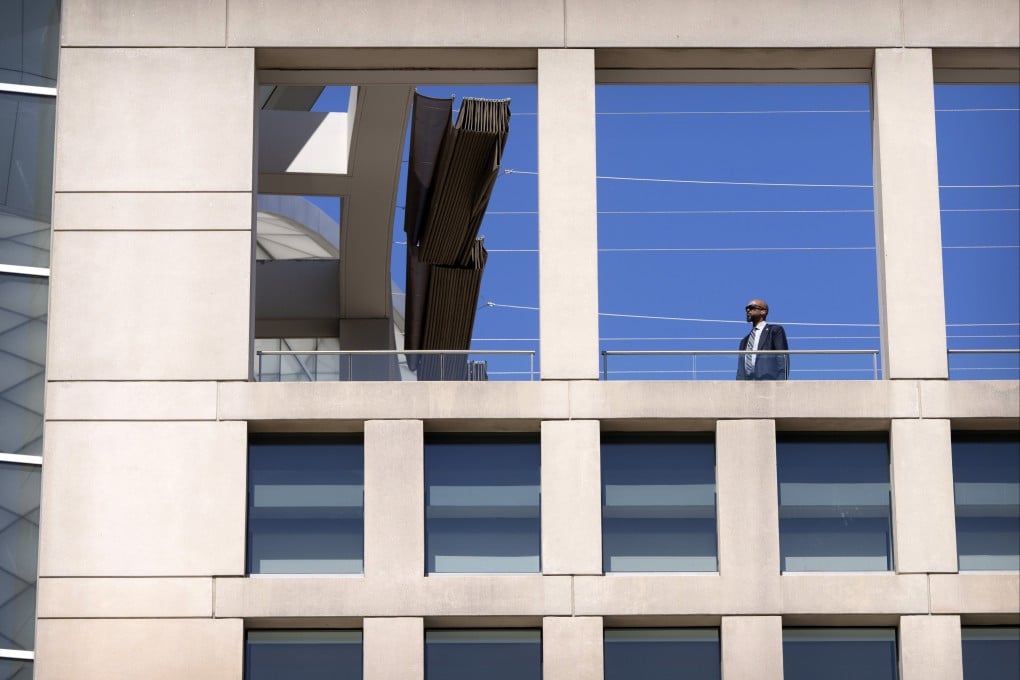 A man wearing an earpiece stands on a balcony at the headquarters of the US Institute of Peace in Washington. Photo: AP