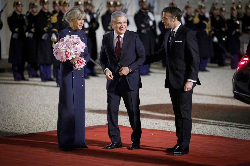French President Emmanuel Macron (right) and his wife Brigitte greet Uzbekistan’s President Shavkat Mirziyoyev as he arrives for a state dinner at the Elysee Palace in Paris on March 12. Uzbek and French companies have signed a cooperation agreement on uranium deposit development. Photo: AFP